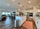 Modern kitchen featuring granite countertops, stainless steel appliances, and an open view to the living area at 5515 Allegre Pl, Cumming, GA 30028