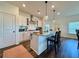 Well-appointed kitchen with a center island, granite countertops, stainless steel appliances, and pendant lighting at 5515 Allegre Pl, Cumming, GA 30028