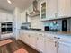 Bright kitchen featuring white cabinets, granite countertops and modern stainless steel appliances at 5515 Allegre Pl, Cumming, GA 30028