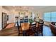 Well-lit kitchen with an island adjacent to a dining room table at 5515 Allegre Pl, Cumming, GA 30028