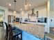 Bright, modern kitchen with stainless steel appliances, granite counters, and a center island with pendant lighting at 5515 Allegre Pl, Cumming, GA 30028