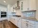 Kitchen with white cabinets, granite countertops and stainless steel appliances at 5515 Allegre Pl, Cumming, GA 30028