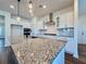 Close-up on kitchen island with granite countertop and pendant lighting at 5515 Allegre Pl, Cumming, GA 30028