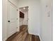 View into the laundry room featuring wood-look floors and cabinets for plenty of storage space at 5515 Allegre Pl, Cumming, GA 30028