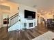 Living room with fireplace, open to kitchen and stairs to second floor at 5515 Allegre Pl, Cumming, GA 30028