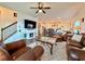 Spacious living room featuring a fireplace, leather furniture, and an open floor plan at 5515 Allegre Pl, Cumming, GA 30028