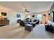 This spacious living room offers ample seating, natural light, and a ceiling fan for added comfort at 5515 Allegre Pl, Cumming, GA 30028