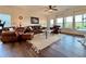 Cozy living room with leather furniture and a decorative ceiling fan at 5515 Allegre Pl, Cumming, GA 30028