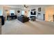 This expansive living room features neutral carpet, abundant seating, and a modern entertainment setup at 5515 Allegre Pl, Cumming, GA 30028