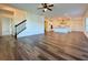 Open-concept living room featuring wood-look floors that lead into a kitchen with a large island at 5515 Allegre Pl, Cumming, GA 30028