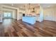 Open living space with a kitchen island, hardwood floors, and a view of the dining area at 5515 Allegre Pl, Cumming, GA 30028