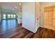 Open-concept living space with hardwood floors, white trim, and a view of the bathroom and backyard at 5515 Allegre Pl, Cumming, GA 30028