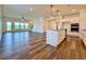 Open living space with a kitchen island, hardwood floors, and a view of the backyard at 5515 Allegre Pl, Cumming, GA 30028