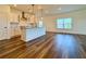 Open living space featuring a kitchen island with bar seating and modern pendant lighting at 5515 Allegre Pl, Cumming, GA 30028