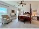 The main bedroom offers a four-poster bed, a comfortable chair, and an abundance of natural light at 5515 Allegre Pl, Cumming, GA 30028