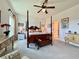 Bright main bedroom with a four-poster bed, a cozy seating area, and neutral decor at 5515 Allegre Pl, Cumming, GA 30028