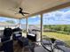 Outdoor patio with ceiling fan, comfortable seating, and backyard views at 5515 Allegre Pl, Cumming, GA 30028