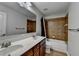 Bathroom featuring double vanity, decorative mirror and tiled shower with tub at 5976 Princeton Run Trl, Tucker, GA 30084