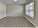 Bedroom features hard surface floors, large window, and a closet at 5976 Princeton Run Trl, Tucker, GA 30084