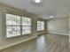 Bedroom featuring hardwood floors and two large windows for lots of natural light at 5976 Princeton Run Trl, Tucker, GA 30084