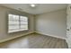 A bright and airy bedroom featuring fresh paint, modern floors, and a closet at 5976 Princeton Run Trl, Tucker, GA 30084