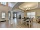 Open-concept dining area with hardwood floors and contemporary chandelier is spacious and bright at 5976 Princeton Run Trl, Tucker, GA 30084