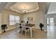 Dining room with wainscoting, modern chandelier, bright natural light, and a natural color pallet at 5976 Princeton Run Trl, Tucker, GA 30084