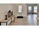 Inviting foyer with neutral walls and floors with a view into the living room with many windows at 5976 Princeton Run Trl, Tucker, GA 30084