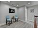 Second story hallway, featuring wood handrail and sitting area with light blue chairs at 5976 Princeton Run Trl, Tucker, GA 30084