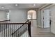 Second story landing, featuring wood handrail, archway to dining area and open doorways at 5976 Princeton Run Trl, Tucker, GA 30084