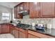 Gourmet kitchen features stainless steel appliances, granite countertops, and custom cabinetry at 5976 Princeton Run Trl, Tucker, GA 30084