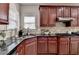 Gourmet kitchen features stainless steel appliances, granite countertops, and custom cabinetry at 5976 Princeton Run Trl, Tucker, GA 30084