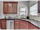 Gourmet kitchen features stainless steel appliances, granite countertops, and custom cabinetry at 5976 Princeton Run Trl, Tucker, GA 30084