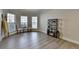 Bright living room with light floors, large windows, and decorative shelving and seating at 5976 Princeton Run Trl, Tucker, GA 30084