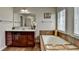 Main bathroom featuring a soaking tub, a large vanity, and lots of natural light at 5976 Princeton Run Trl, Tucker, GA 30084