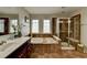Main bathroom featuring a soaking tub, a separate tiled shower, and a vanity at 5976 Princeton Run Trl, Tucker, GA 30084
