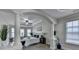 Bright main bedroom featuring decorative columns, tray ceiling, ceiling fan, and lots of natural light at 5976 Princeton Run Trl, Tucker, GA 30084