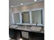 Bathroom featuring a double vanity with granite countertop and framed mirrors with lighting at 685 Egrets Lot 58 Lndg, Covington, GA 30014