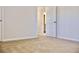 Bedroom with neutral walls, white trim, carpeted floors, and open doorway to bath at 685 Egrets Lot 58 Lndg, Covington, GA 30014