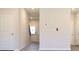 Clean hallway featuring a gray-toned wood-look floor with a doorway and staircase at 685 Egrets Lot 58 Lndg, Covington, GA 30014