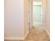 Hallway with neutral walls, white trim, carpeted floors, and multiple doorways at 685 Egrets Lot 58 Lndg, Covington, GA 30014
