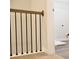 Interior hallway featuring carpet, a light wood and metal railing, and entry into a storage area at 685 Egrets Lot 58 Lndg, Covington, GA 30014