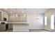 Well-lit kitchen with stainless appliances and gray cabinets with an adjoining dining area at 685 Egrets Lot 58 Lndg, Covington, GA 30014