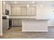 Contemporary kitchen with stainless appliances, gray cabinets, and a granite-topped island at 685 Egrets Lot 58 Lndg, Covington, GA 30014
