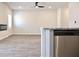 Bright living room with hardwood floors, fireplace, ceiling fan, and stainless steel appliances at 685 Egrets Lot 58 Lndg, Covington, GA 30014
