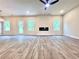 Spacious living room with hardwood floors, a modern fireplace, and natural light at 685 Egrets Lot 58 Lndg, Covington, GA 30014