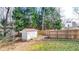 The backyard features a storage shed, and a basketball hoop, all enclosed by a wooden fence at 1074 Fieldstone Dr, Canton, GA 30114