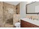 An elegant bathroom featuring a tiled shower, vanity with marble countertop, and modern fixtures at 1074 Fieldstone Dr, Canton, GA 30114