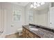 Bathroom showcasing granite countertops, stylish mirrors, a toilet, and a shower-tub combo at 1074 Fieldstone Dr, Canton, GA 30114