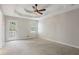 Spacious bedroom with a tray ceiling, ceiling fan, a door that leads to a balcony, and large window at 1074 Fieldstone Dr, Canton, GA 30114